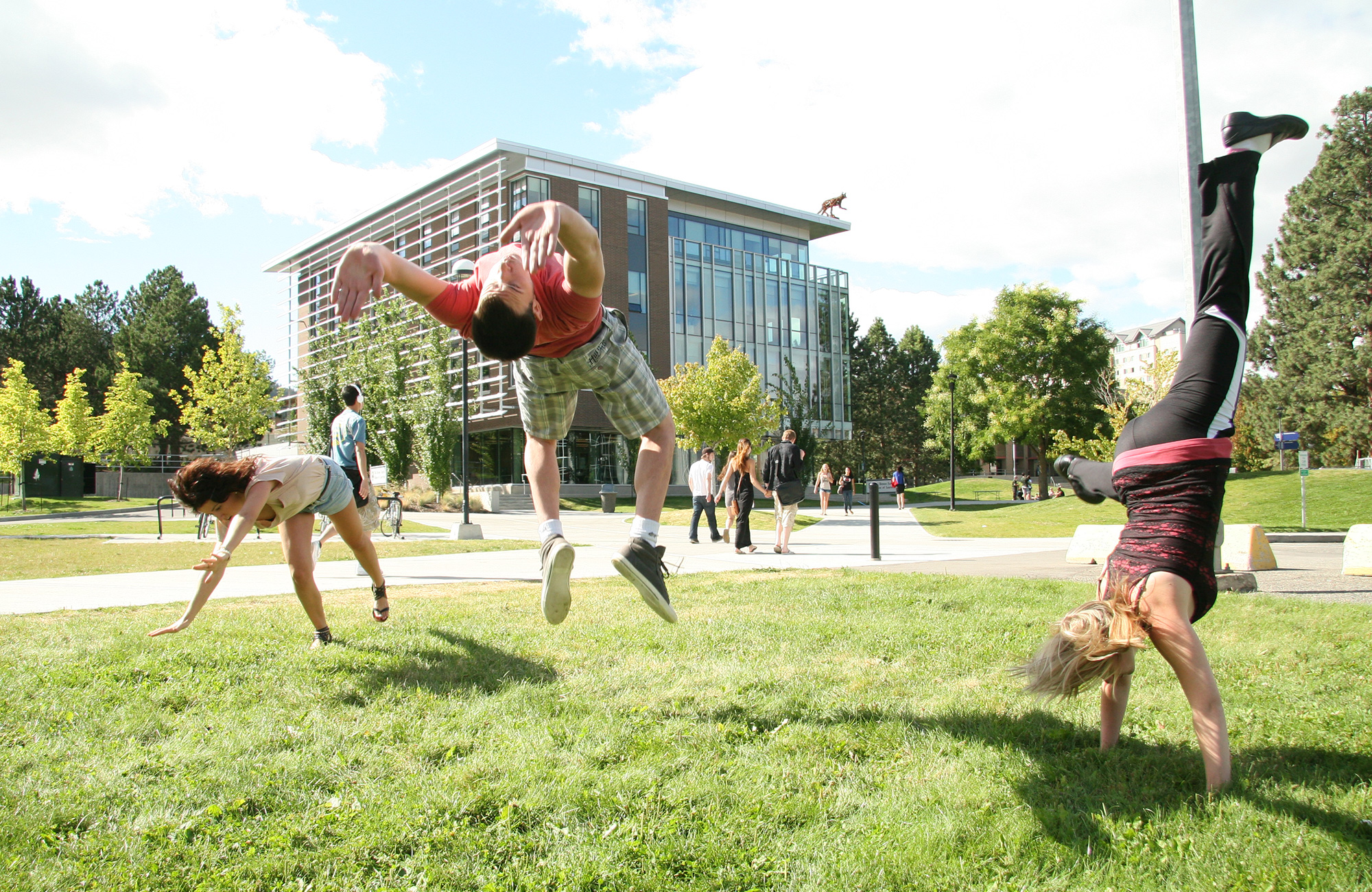 a student doing a backflip on campus at Thompson Rivers University