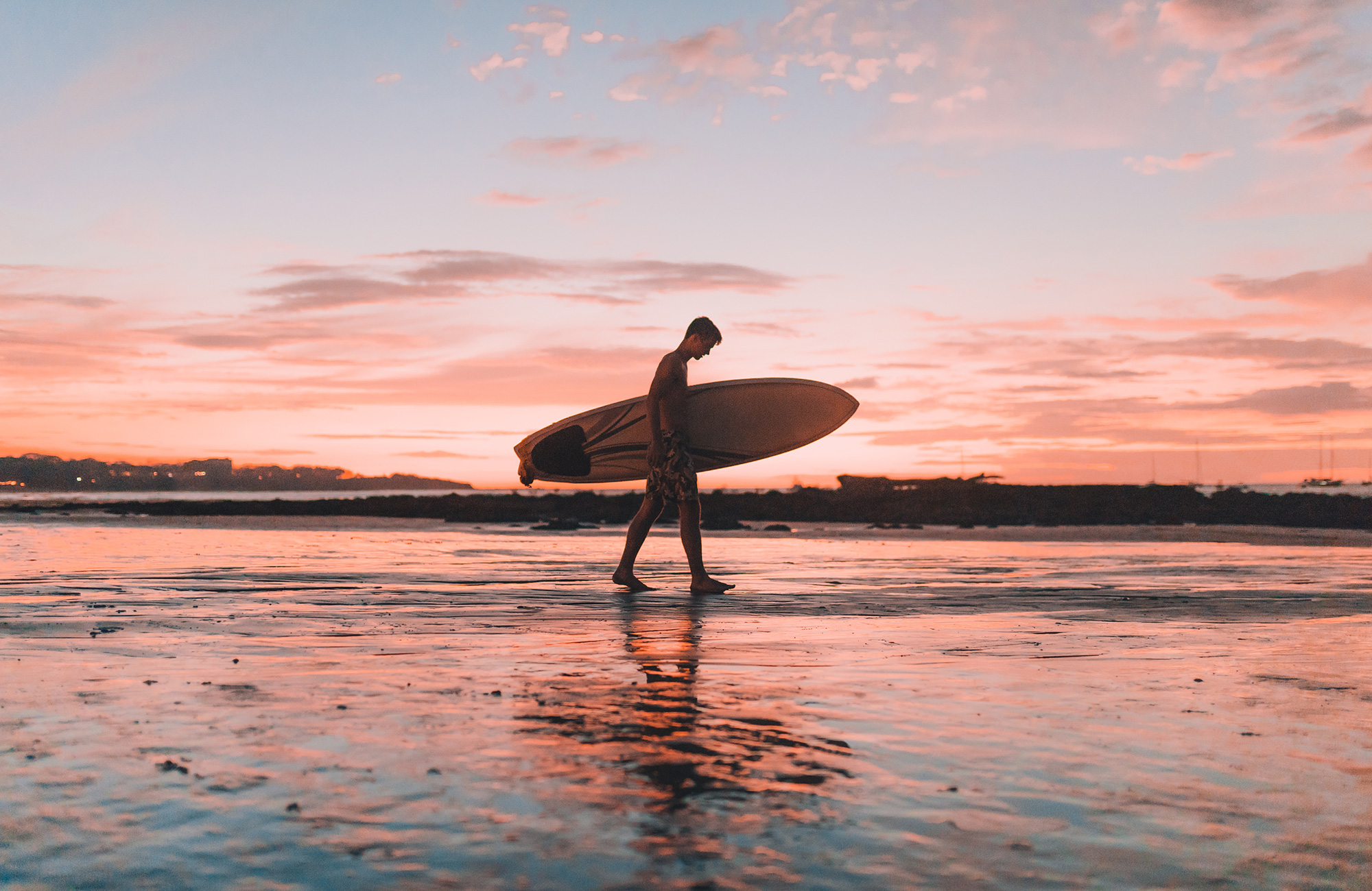 surfing-dude-with-surfboard-at-sunset-cover