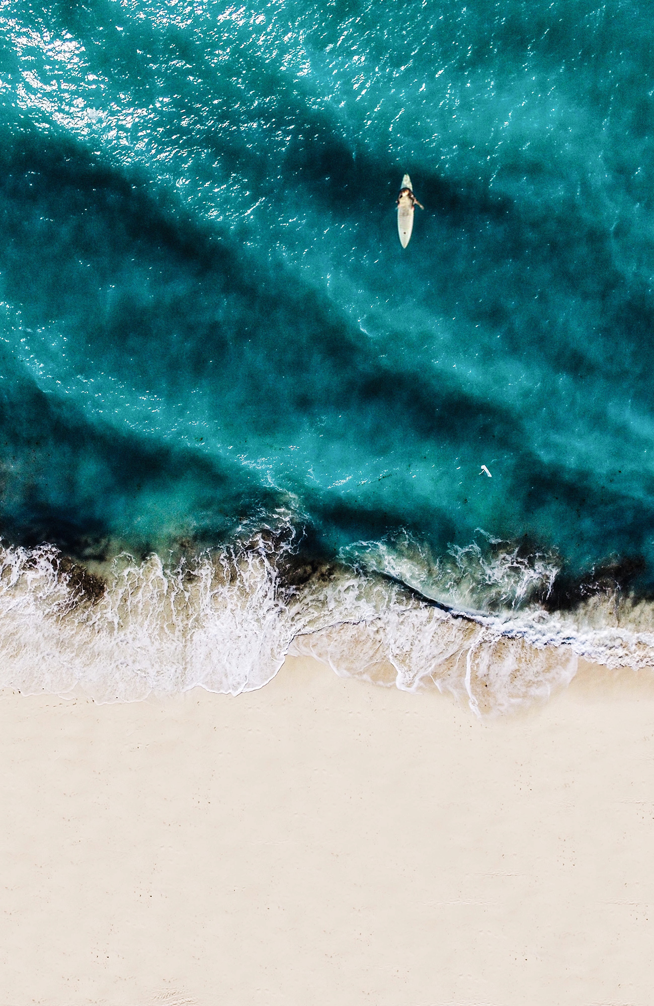 surfing-surfer-in-water-drone-shot-sidebar