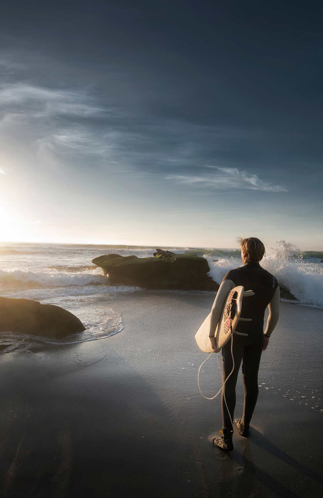 surfing-general-guy-standing-on-beach-with-surfboard-sidebar