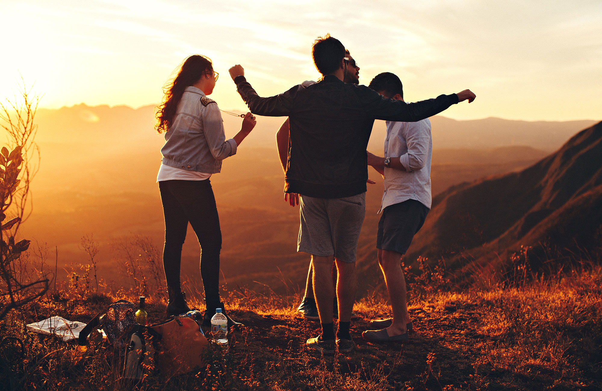 four interns in the usa dancing on the top of a hill