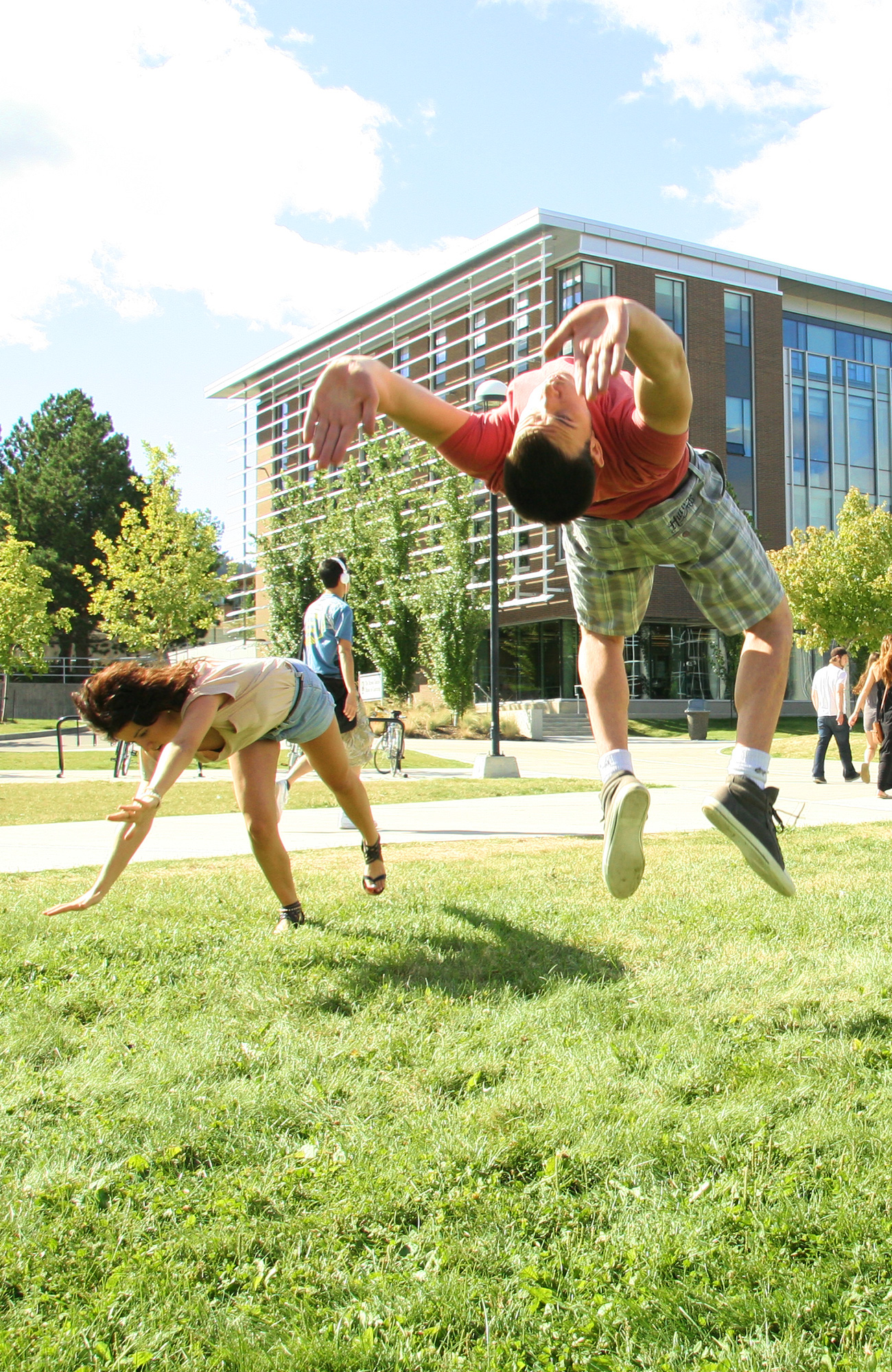students in Canada doing a backflip on the campus of Thompson Rivers University