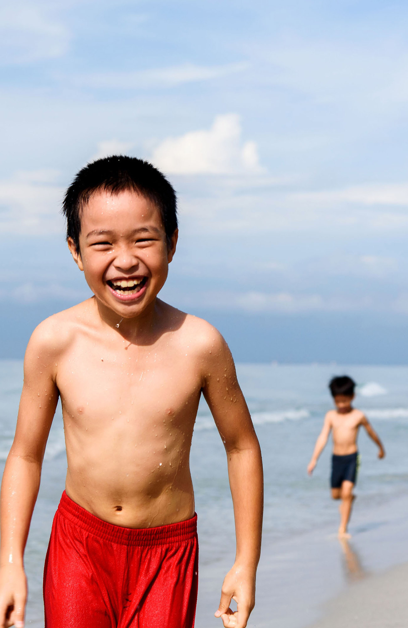volunteering-asia-thailand-volunteering-boy-on-thai-beach-swimsuit-sidebar