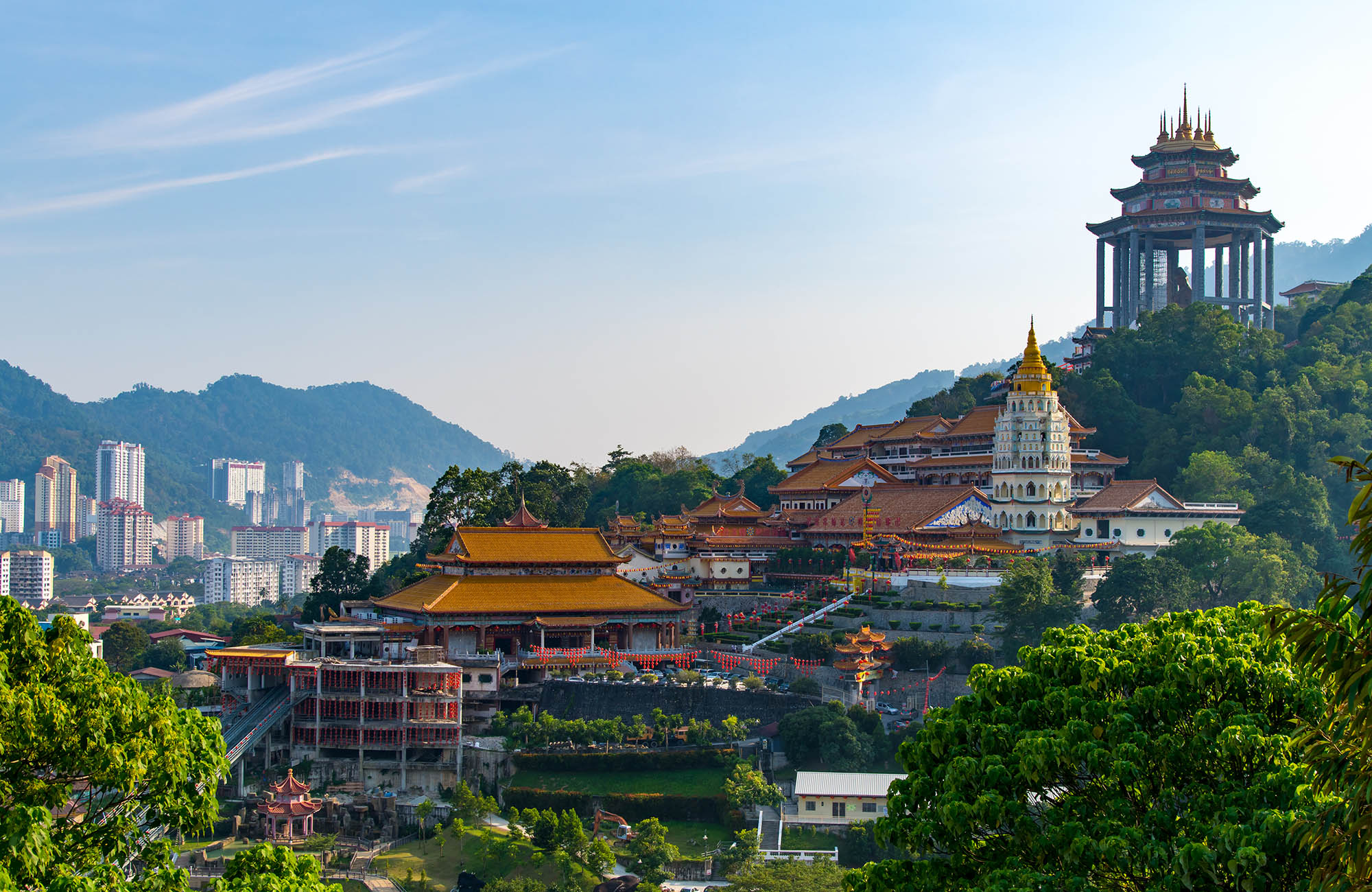 Skyline of Georgetown with lots of temples and churches, nestled in the green hills of Malaysia