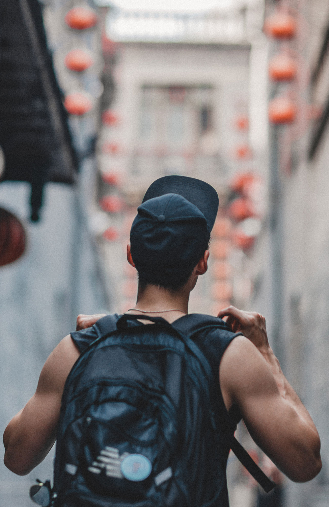 an intern abroad walking in the small streets with his backpack