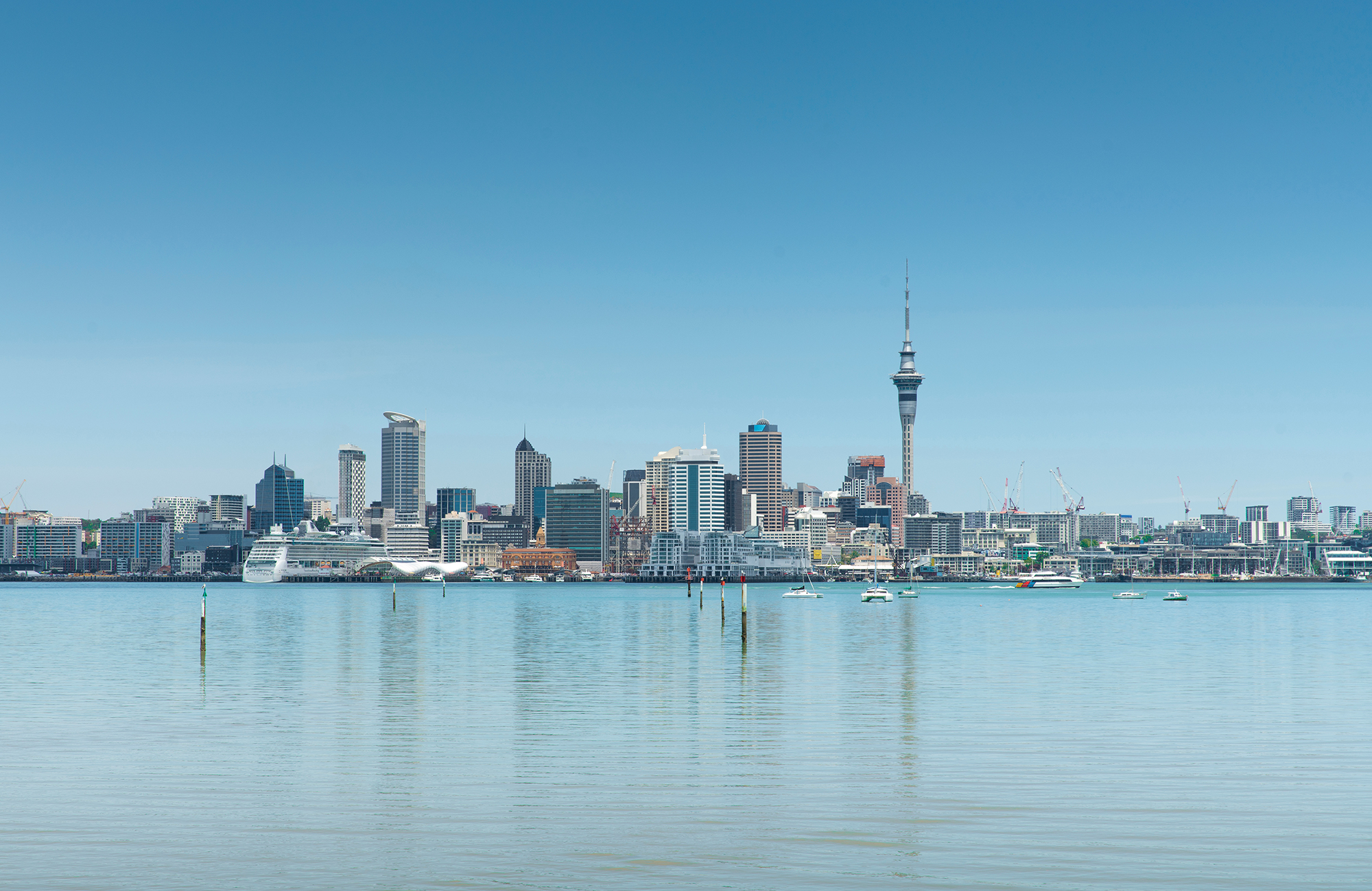 the skyline of auckland in new zealand and the blue water