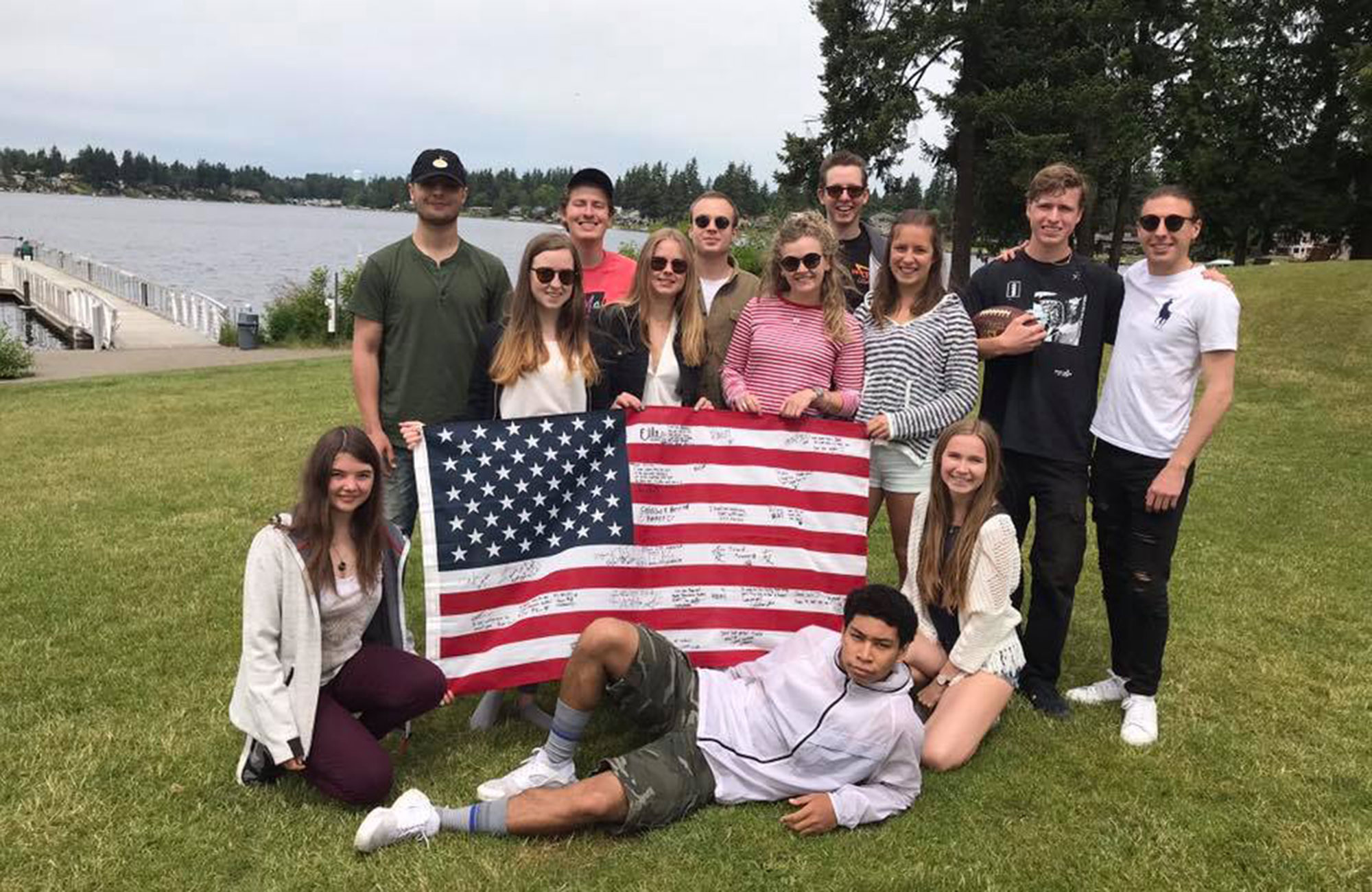 Jakob and friends holding the american flag while studying at green river college