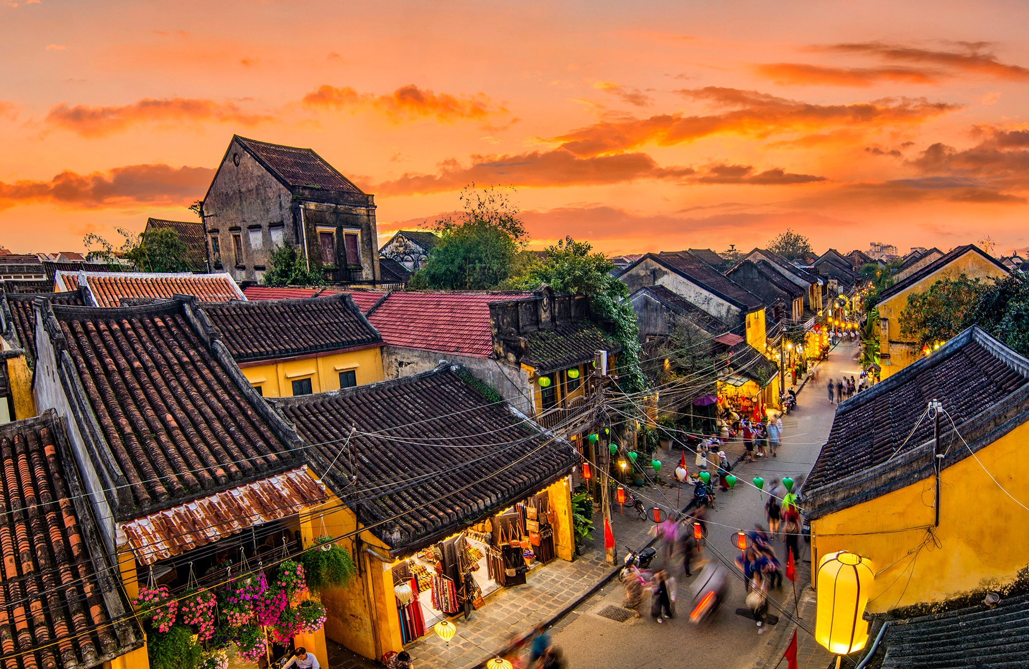 Cosy street in Hoi An with old houses during sunset
