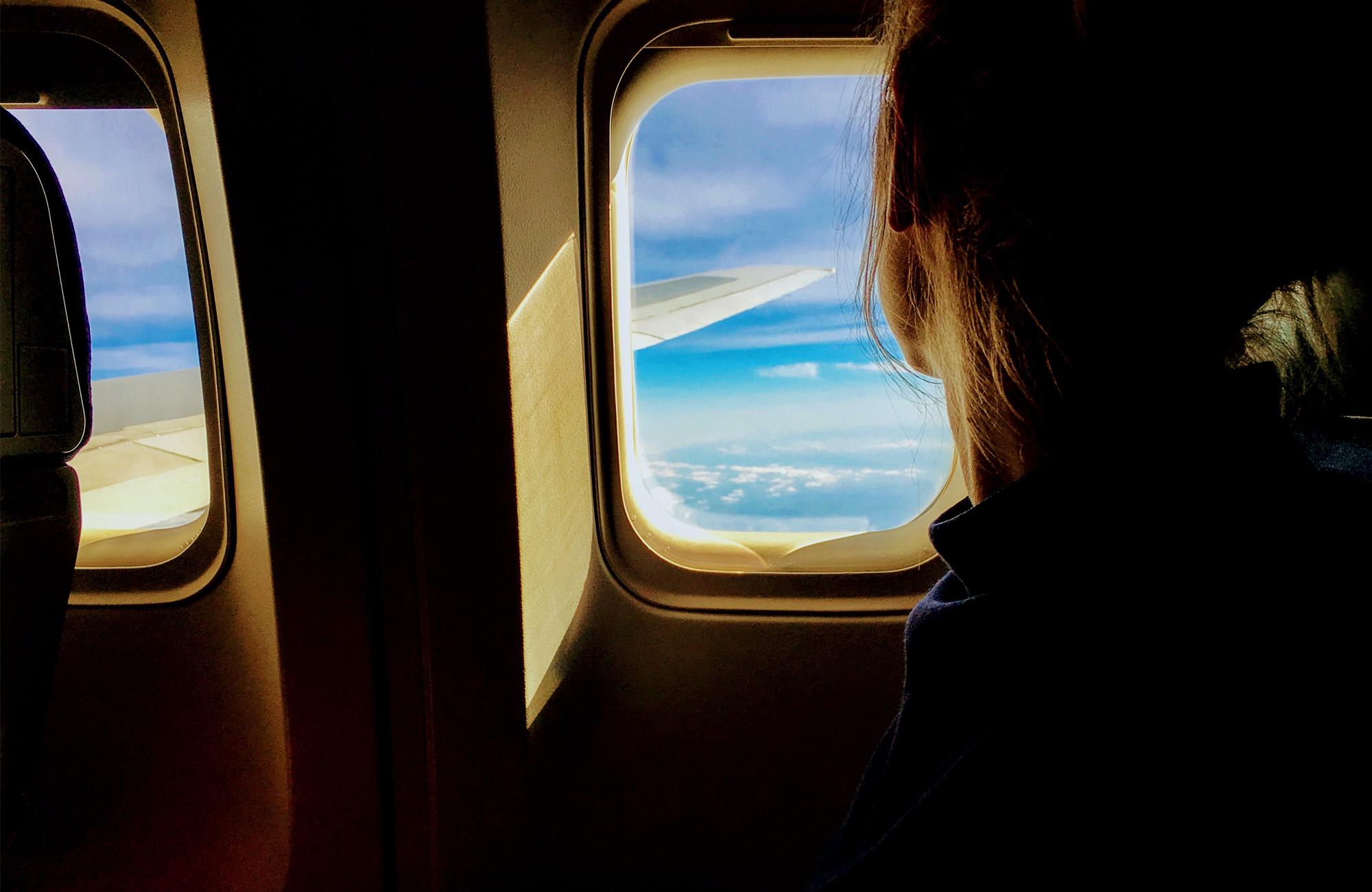 Traveling Alone Girl Looking Out Of A Plane