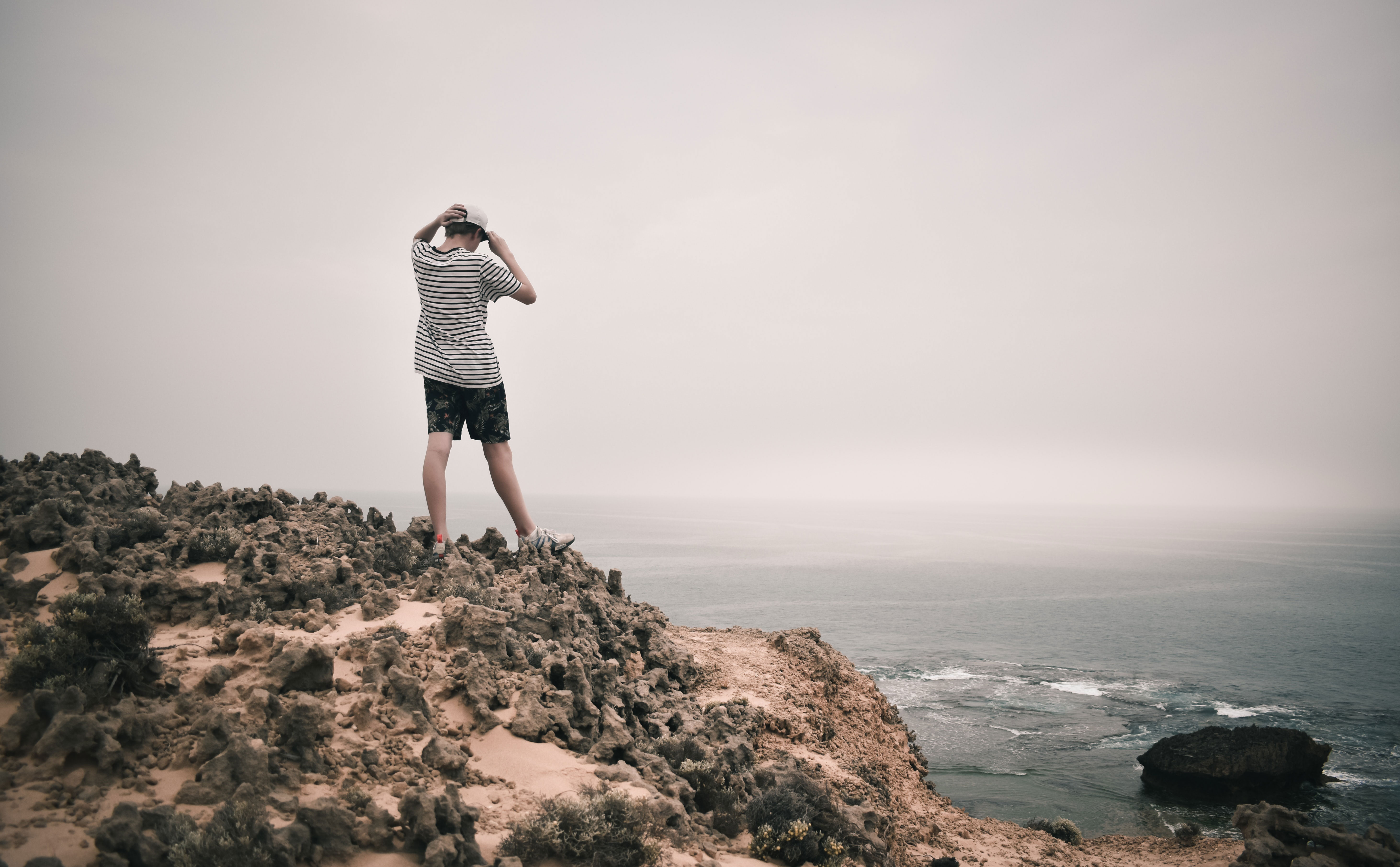 Guy Standing On Rocks Near The Ocean In Australia
