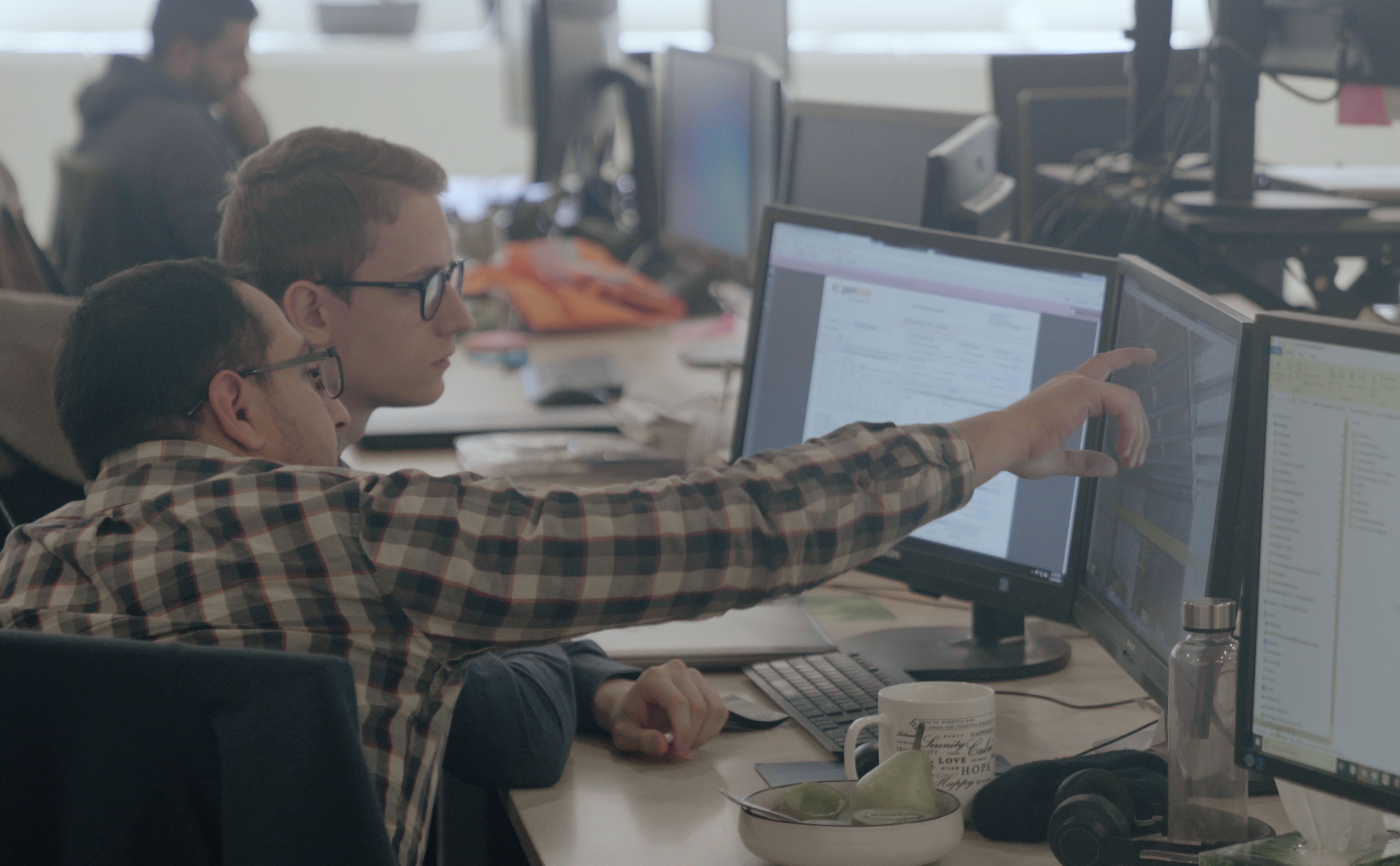 Intern and coworker collaborating in the office together
