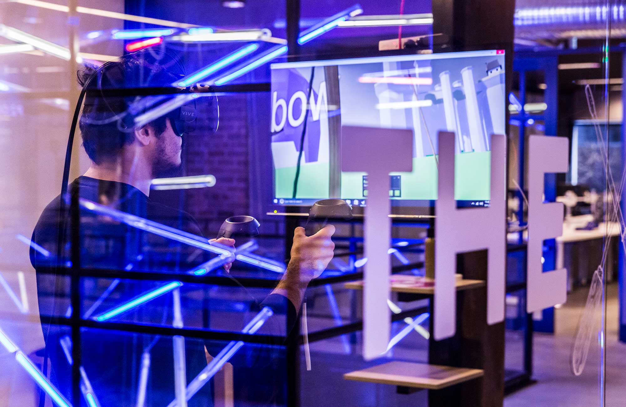 A male student with VR glasses operating a controller