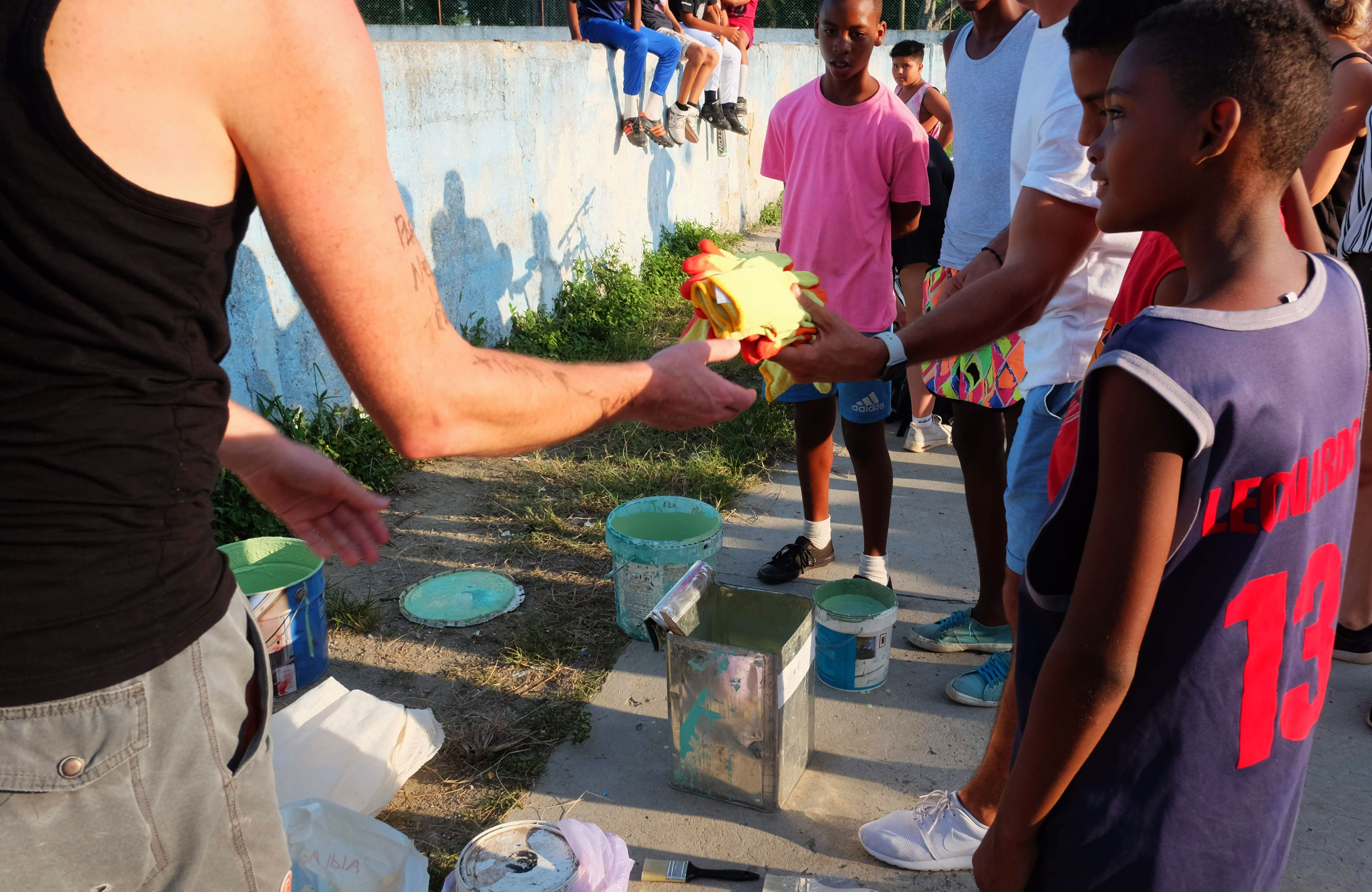 Volunteers and children painting on a volunteering project in Cuba