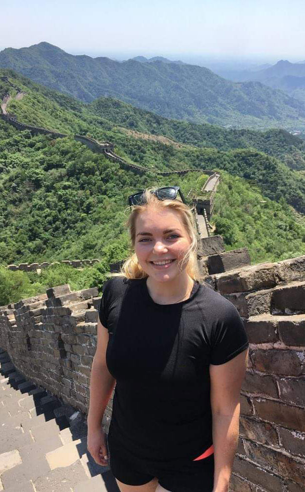 Lizzie with a big smile at the Great Wall during her trip to China