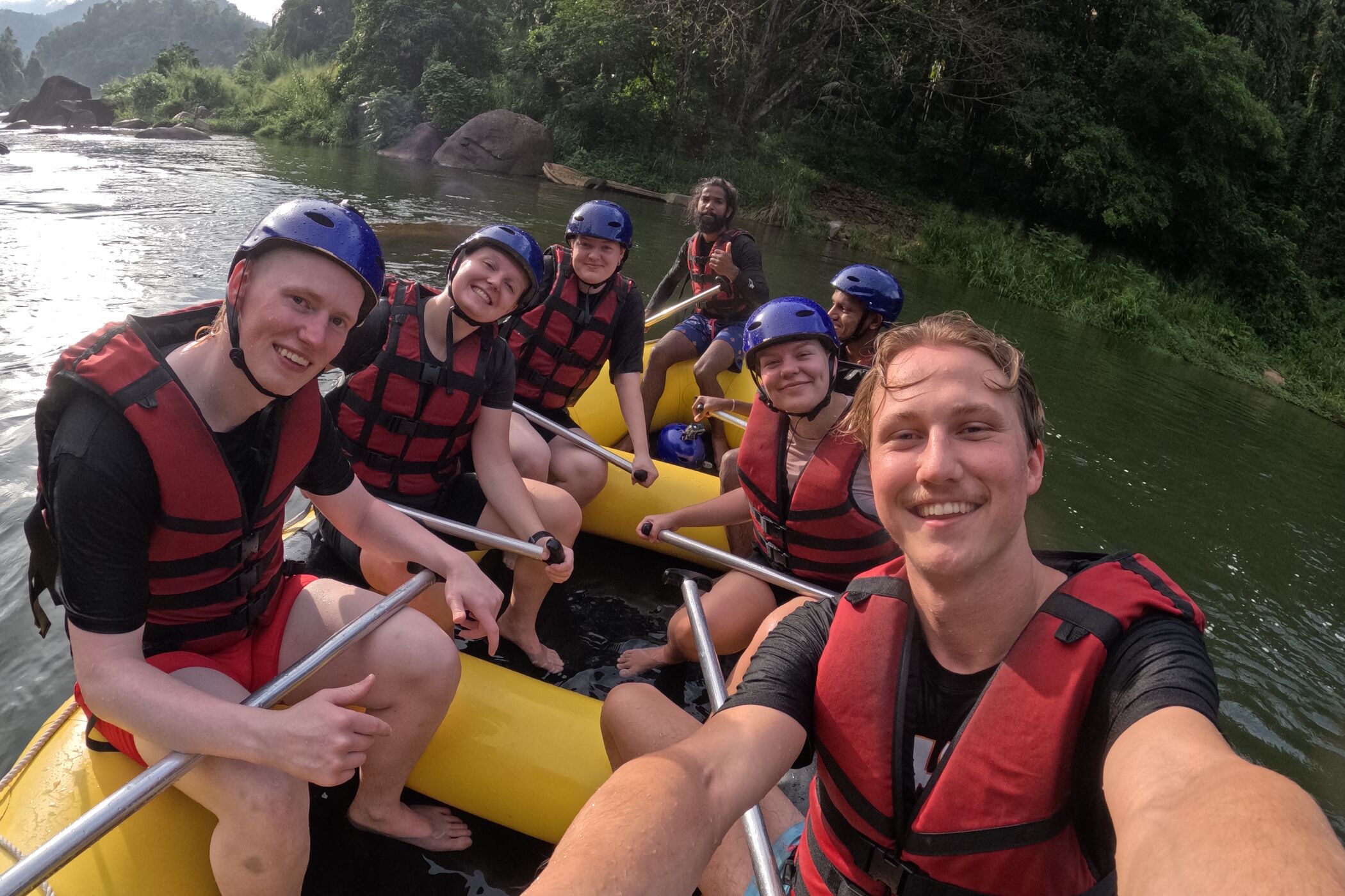 Three people freediving along a rope in a blue ocean in Indonesia