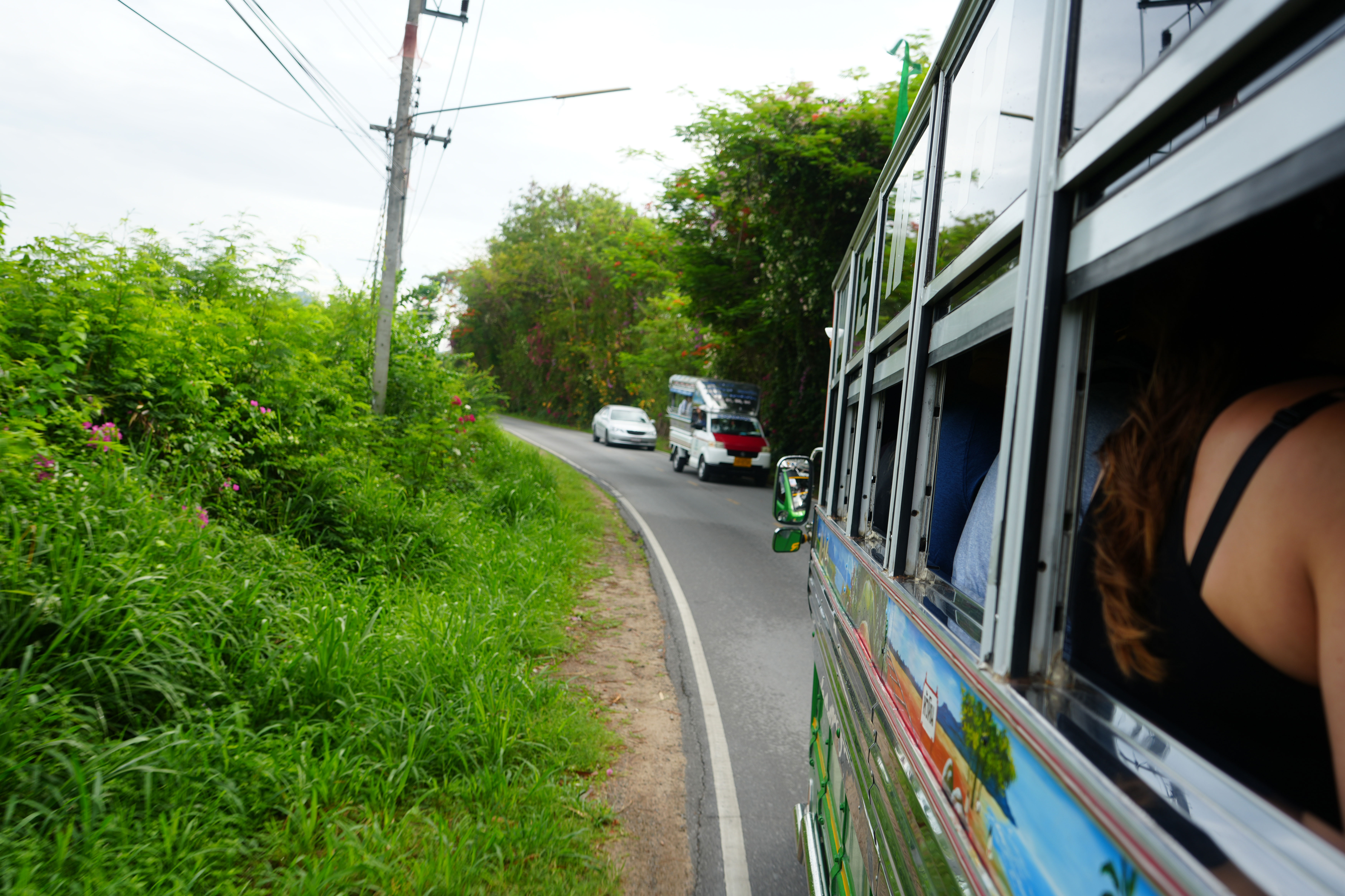 Travellers In A Bus In Thailand In A Green Landscape